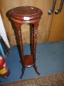 A circular Mahogany lamp Table having twist legs united by a lower shelf and with splay scroll feet,