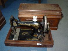 A Singer sewing machine in a wooden case.