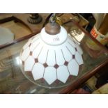 A conical glass lamp shade in geometric design, white, mauve and gilt.