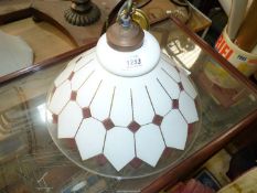 A conical glass lamp shade in geometric design, white, mauve and gilt.