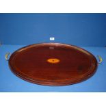 A 19th century Mahogany and satinwood oval butlers tray with brass handles, 26" long.