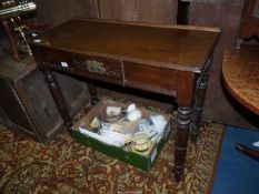 An Oak and other woods Side Table having a central frieze drawer and standing on turned legs,