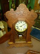 An antique American 'Gingerbread' chiming Wall Clock by Waterbury Clock Co - mechanism requires