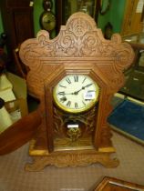 An antique American 'Gingerbread' chiming Wall Clock by Waterbury Clock Co - mechanism requires