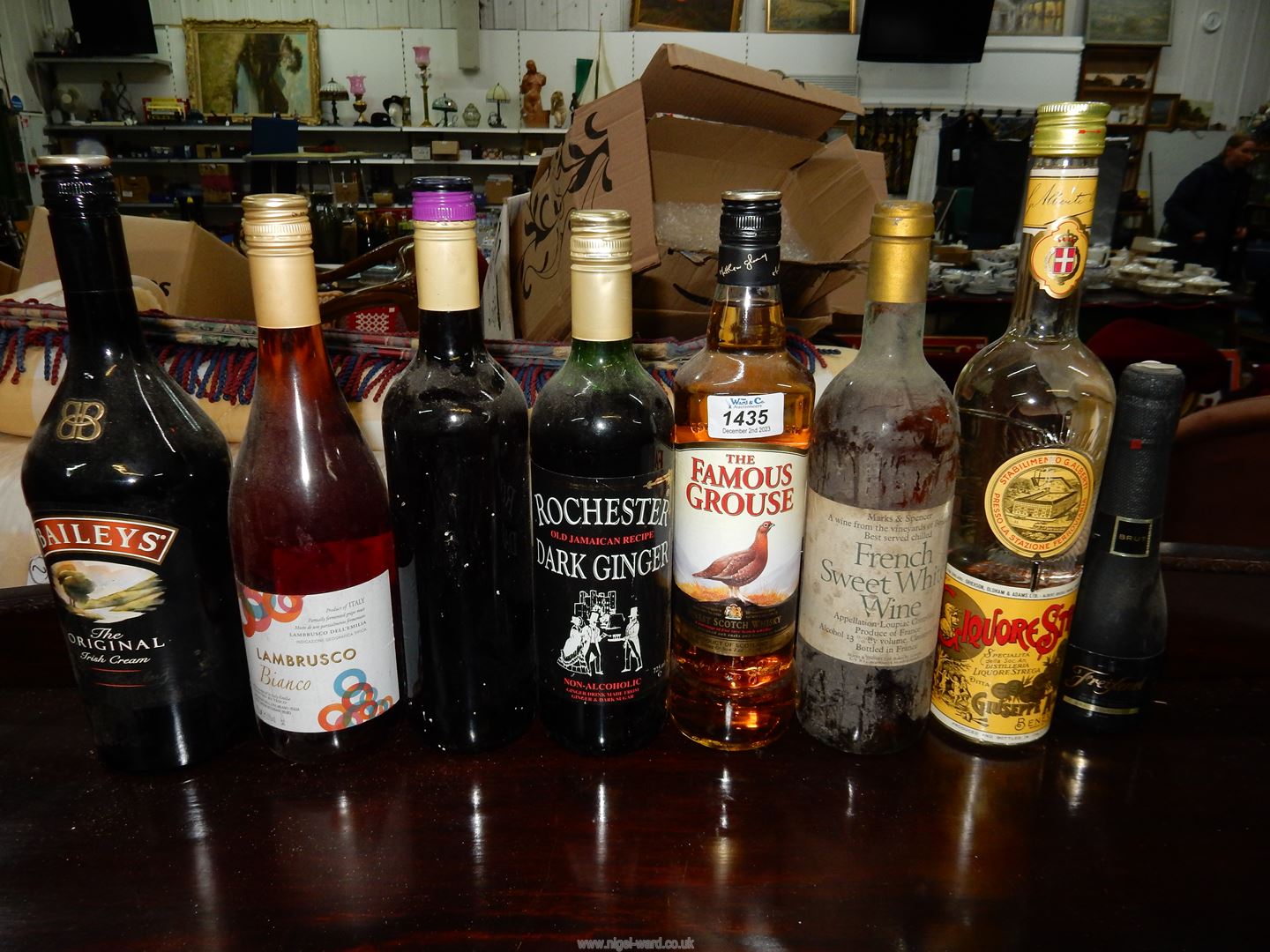 Eight bottles of Christmas cheer including one unlabelled but lid marked "Oxford Landing".