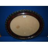 A dark wood oval glazed frame, aperture 19" x 16".