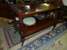 A William IV Mahogany two tier Dumb Waiter having turned and lobed supports and large brass castors