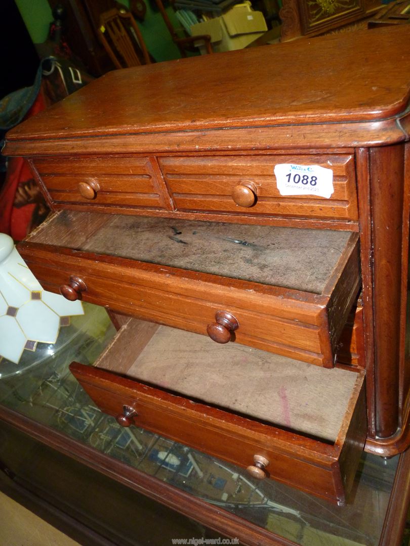 A 19th century miniature oak chest of two short and three long graduated drawers standing on turned - Image 2 of 2