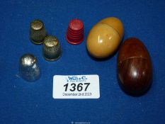 Two thimble holders including one with small reel and spindle and four thimbles including brass and