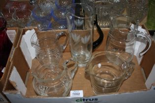 A quantity of jugs including a lemonade jug with green handle and floral pattern.