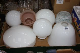 A box of globe shaped opaque Light shades plus two pink smaller ones.