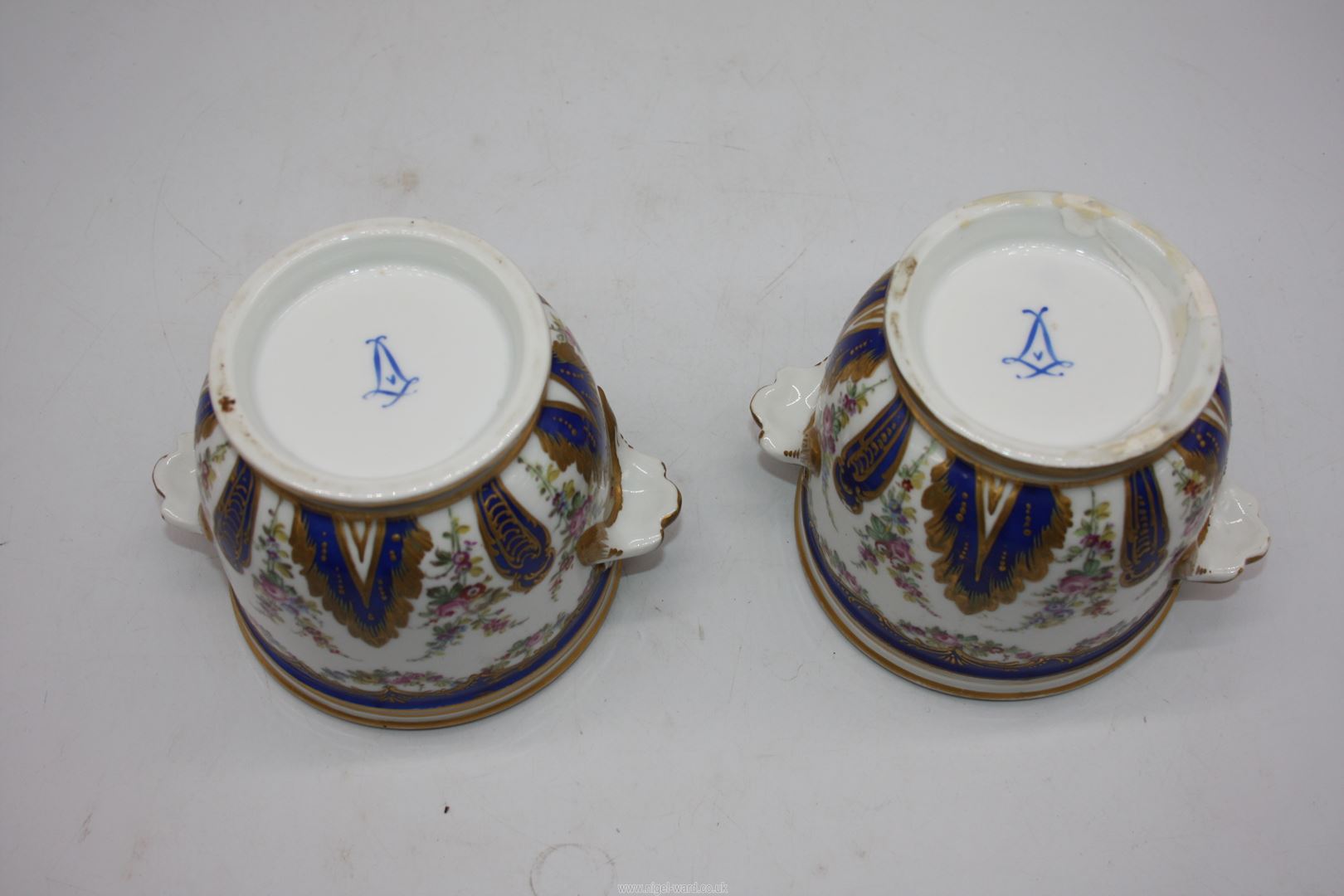 A pair of small Urns with blue, gilt and floral decoration, blue cross swords mark to base. - Image 4 of 4