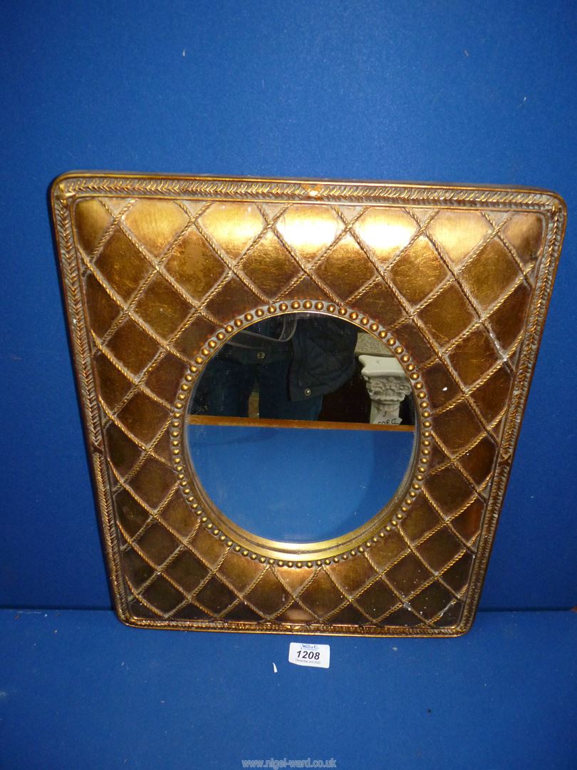 A contemporary wall hanging oval Mirror set in a broad padded effect gilded rectangular frame with