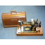 A Singer sewing machine in a wooden case.