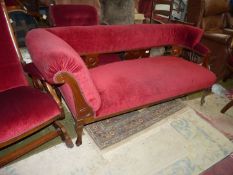 A Satinwood framed Chaise Longue standing on cabriole front legs and upholstered in maroon,