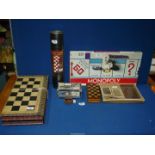 A quantity of board games to include; American Monopoly, travel Chess set, travel Trivia,