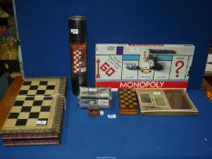 A quantity of board games to include; American Monopoly, travel Chess set, travel Trivia,