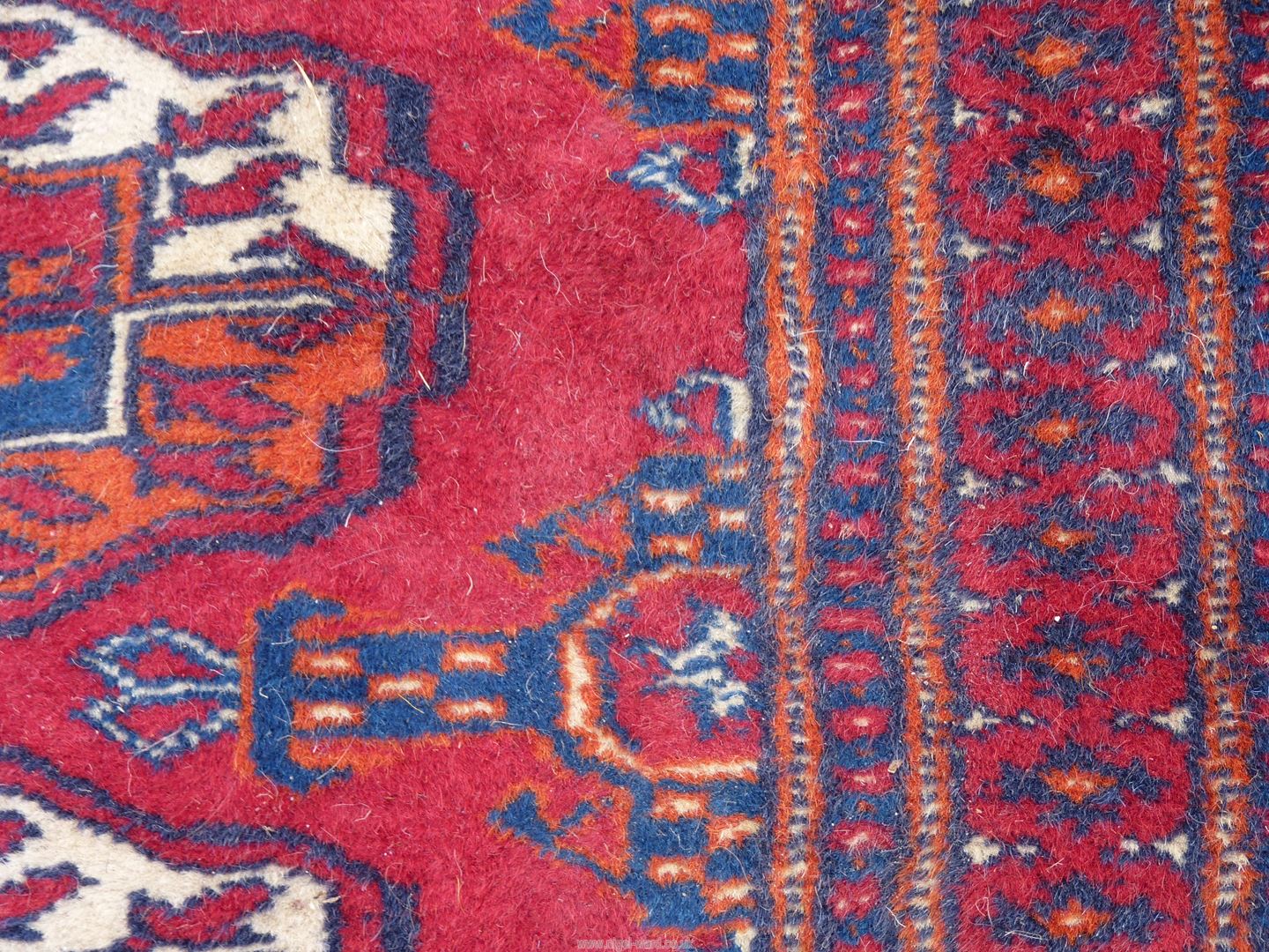 A large carpet in red and blue geometric design. 173" x 121". - Image 5 of 6