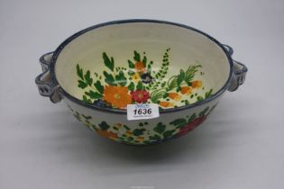 A large Italian footed bowl with floral decoration, 10 1/2" diameter.