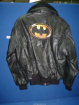 A black leather flying jacket with detachable fur collar and having the Batman logo on the back,