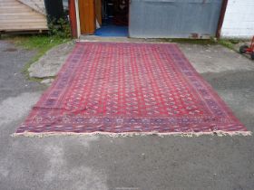 A large carpet in red and blue geometric design. 173" x 121".