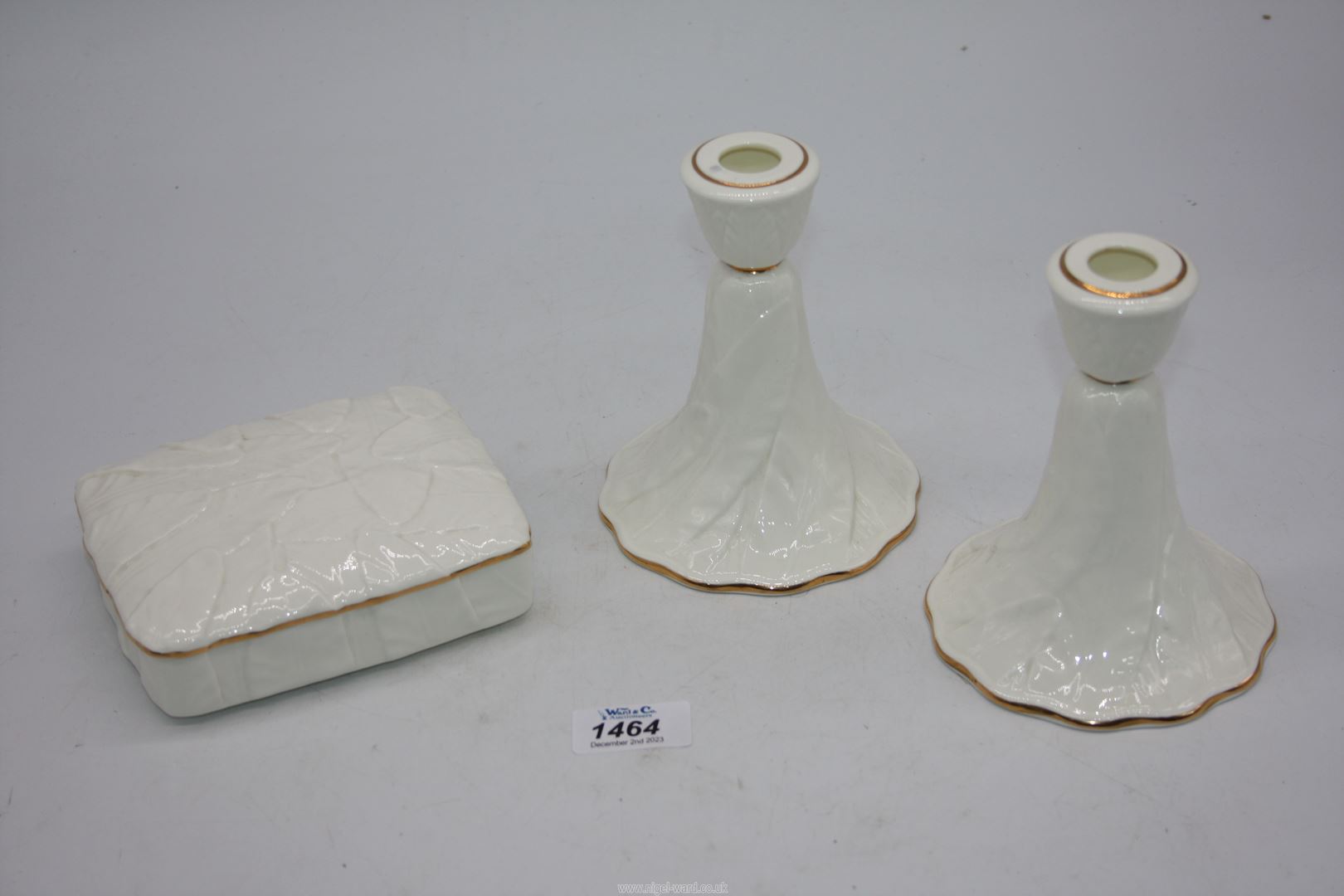 A pair of Royal Worcester fern leaf Candlesticks and a lidded dish.