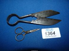 An early 19th century pair of shears and a tiny scissors.