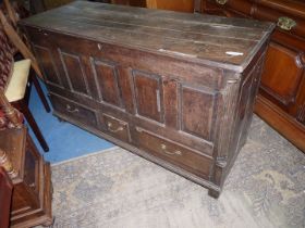 An early 19th century/18th century four panel dark Oak mule chest having raised and fielded panels