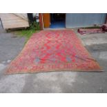 A large carpet in jewel colours. 172" x 114".