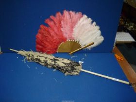 An ostrich feather Fan and an Edwardian parasol (the fabric badly distressed and in need of