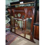 A Mahogany overmantel Mirror having multiple bevelled mirrors and a shelf with turned supports,