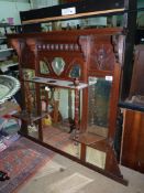 A Mahogany overmantel Mirror having multiple bevelled mirrors and a shelf with turned supports,