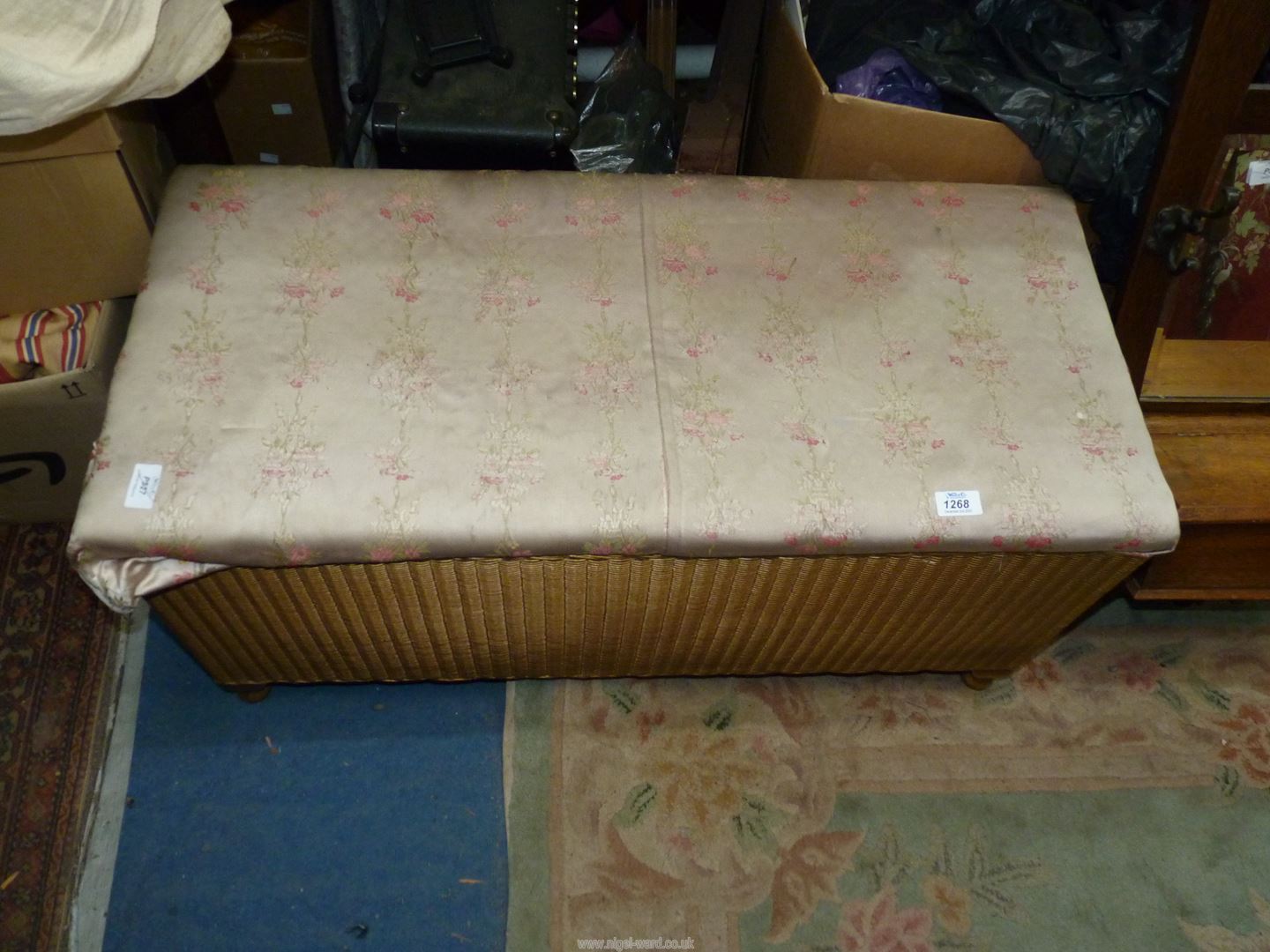 A Lloyd Loom type linen Basket/Stool in gold, standing on brief cabriole legs,