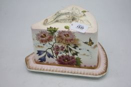 A pretty German porcelain wedge shaped cheese dish on stand, painted with flowers on a blush ground,