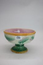 A Majolica style footed bowl with basket weave and palm leaf decoration and bamboo effect rims to
