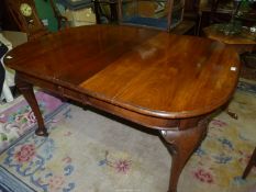 A Walnut/Mahogany wind-out extending Dining Table standing on elegant cabriole legs,