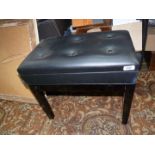 A contemporary black/ebony coloured piano stool,