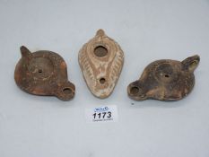 Three ancient Roman terracotta oil lamps.
