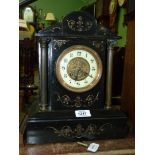 A black slate mantle clock, with key, 10" wide x 13" high.