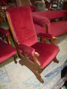 A Satinwood framed maroon upholstered Rocking fireside Chair, matches previous two lots.