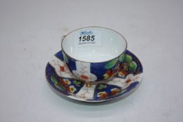A dainty porcelain tri footed cabinet teacup with saucer,