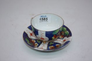 A dainty porcelain tri footed cabinet teacup with saucer,