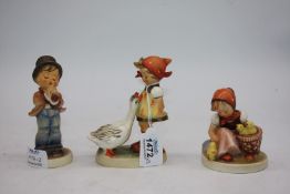 A Goebel figure of goose girl, 5" tall and Serenade, 5" tall and a chick girl, 3 1/4" tall.