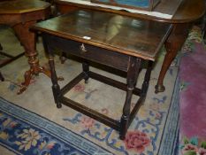 A 19th century Oak Side Table standing on turned legs united by perimeter stretchers and having a
