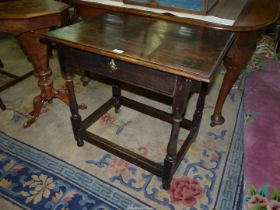 A 19th century Oak Side Table standing on turned legs united by perimeter stretchers and having a