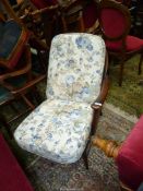 A stickback Ercol type open armed Fireside Armchair having cream ground blue floral decorated
