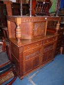 A Priory Oak style reproduction Court Cupboard having toggle door latches,