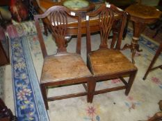 A pair of Georgian Oak side Chairs having a solid seats and fretworked back splats (one backrest