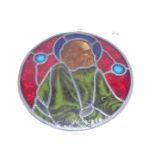 A Victorian leaded stained glass roundel centred with the portrait of a bearded gentleman,