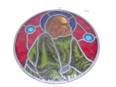 A Victorian leaded stained glass roundel centred with the portrait of a bearded gentleman,